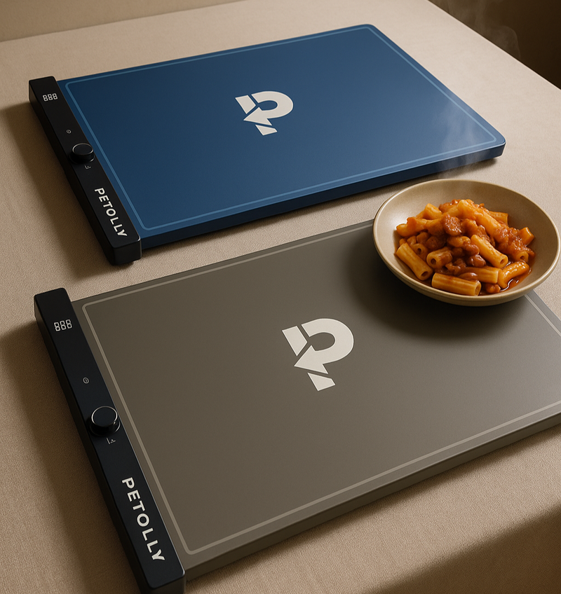 Two portable heating pads with Petolly logo on a surface with a bowl of food.